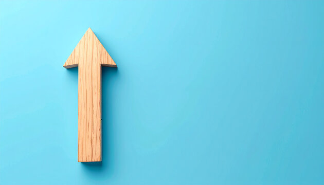 Minimalist wooden arrow pointing upward on blue background. Forward direction and progress