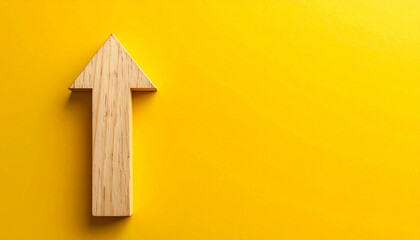 Minimalist wooden arrow pointing upward on yellow background. Forward direction and progress