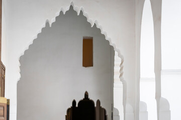 Fototapeta premium Ornate entrance arch and doorway inside the 19th century El Bahia Palace in Marrakesh, Morocco. A lambrequin arch at Bahia Palace, Marrakech. 