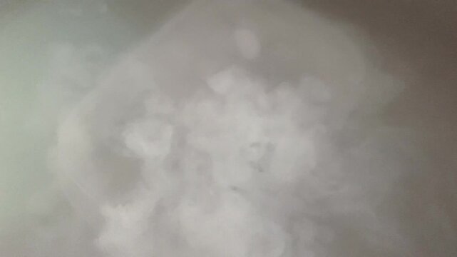 White smoke cloud rising and swirling in air