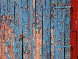 Weathered blue wooden door with peeling paint in Norway