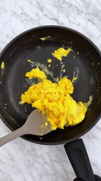 Delicious hot scrambled eggs with warm croissant.