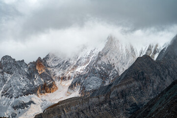 Snow-capped mountains shrouded in mist on the Qinghai-Tibet Plateau