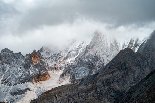 Snow-capped mountains shrouded in mist on the Qinghai-Tibet Plateau
