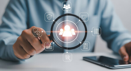 Magnifying Glass Focuses on Digital Human Resources Icons.