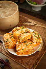 Handmade Spicy Pork Rolls with Green Onions and Bamboo Steamer - Traditional Asian Cuisine