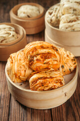Steamed Pork Buns and Scallion Rolls in Bamboo Steamers - Traditional Asian Dim Sum Food