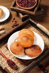 Handmade Fried Sugar Donuts with Red Beans on Rustic Wooden Serving Tray