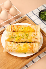Hot Steaming Egg and Ham Pastry Rolls - Fresh Breakfast Omelette Wraps on Wooden Serving Tray