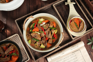 Farmhouse Stewed Goose Dish in Iron Skillet on Rustic Wooden Table Traditional Asian Cuisine