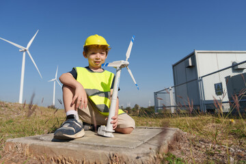 Children are running on a natural energy farm such as windmills and electricity.