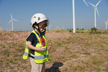 Children are running on a natural energy farm such as windmills and electricity.