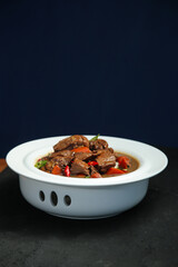 Braised Goose Stew in Rustic Enamel Bowl - Traditional Farmhouse Cooking with Rich Flavors and Vegetables