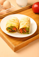 Ham and Egg Breakfast Wraps with Vegetables on Wooden Serving Tray