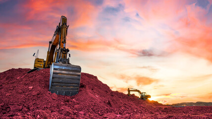 Excavator on earthmoving on sunset. Digger Iron ore mining. Excavator moving. Heavy Machinery in...