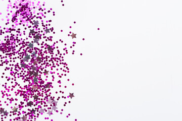 Party pink confetti on color background, top view