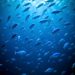 School of Blue Fish Swimming in Deep Ocean Water Sunlight Rays