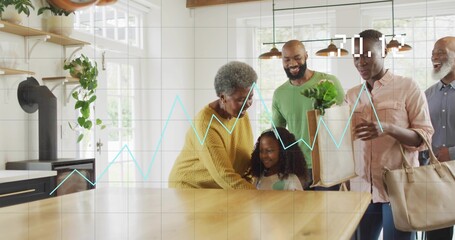 Chatting multigenerational family leaning around wooden kitchen island at home, holding grocery bag