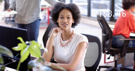 Sitting woman wearing white sleeveless top and chain necklace resting chin at desk with monitor