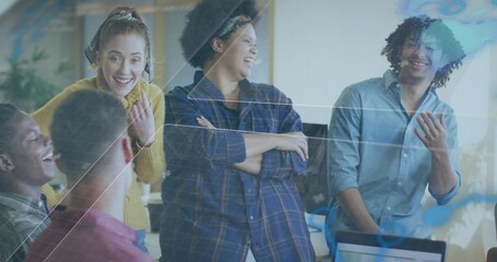 Laughing six casual coworkers discussing at office desk with laptop and reflective glass overlay