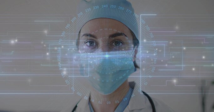 Facing female doctor wearing surgical cap, surgical mask and stethoscope in clinic, with AR HUD