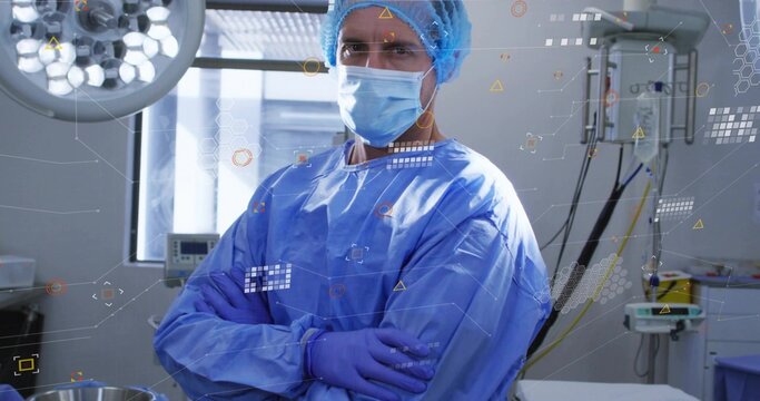 Standing male surgeon folding arms, wearing gown, cap, mask and gloves in OR, HUD overlays