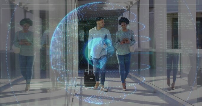 Walking duo pulling suitcase and checking phone in glass hall, white shirt, hologram globe hovering