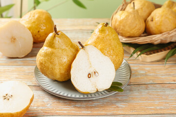 Fresh Chinese Pears Cut in Half Showing White Flesh on Rustic Wood Table with Shallow Depth of Field