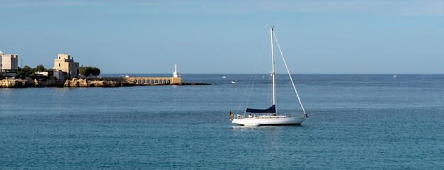 Sailing boat anchored in the harbour in front of Otranto