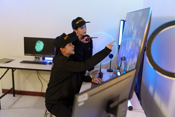 Security officers are checking the TV screen of the CCTV system. 