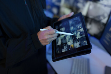 Security officers are checking the TV screen of the CCTV system. 