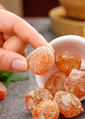 Sugar Coated Dried Kumquat Candy Hand Holding Orange Crystallized Fruit Snack Traditional Asian Confection