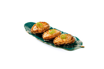 Steamed Abalone Seafood Delicacy on Green Glass Plate with Scallion Garnish