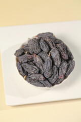 Xinjiang Turpan Black Raisins in White Bowl - Premium Chinese Dried Fruit Snack