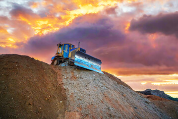 Dozer grading. Dozer recovering landscape at open pit. Process of restoring land. Bulldozer at mine...