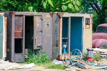 Construction Workers Dismantling and Recycling Old Container Panels Outdoors