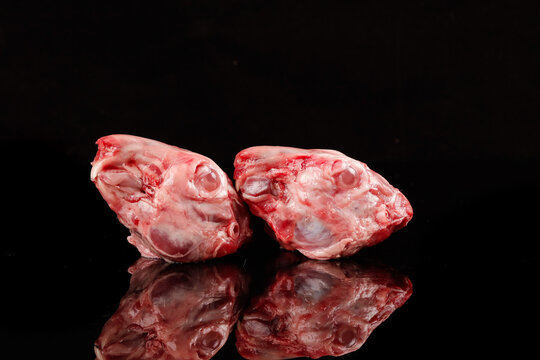 Frozen Rabbit Heads from Chongqing China - Raw Meat for Traditional Cooking on Black Background - Powered by Adobe