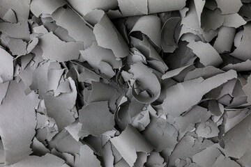 Abstract Background of Gray Cutouts and Curled Material Scraps