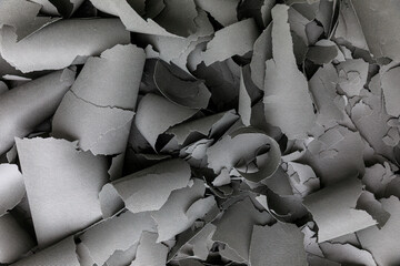 Abstract Background of Gray Cutouts and Curled Material Scraps