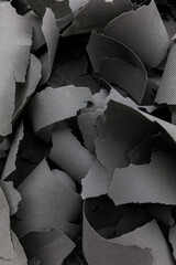 Abstract Background of Gray Cutouts and Curled Material Scraps
