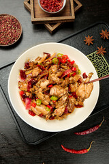 Spicy Stir-Fried Beef Dry Pot Chinese Dish with Red Chilies and Traditional Seasonings on Dark Wood Background