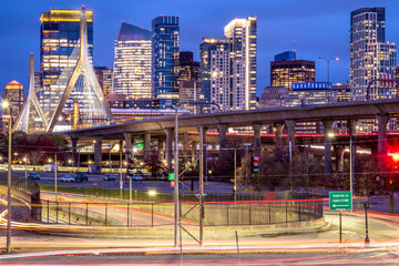 View of the iconic Boston in Massachusetts, USA at night showcasing the North End of the city with its skyscrapers, roads and lights. 
