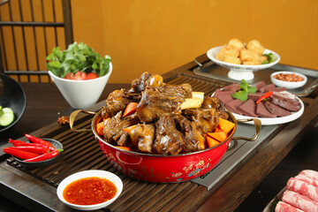 Braised Lamb Stew with Vegetables in Red Pot - Asian Hot Pot Style Meal with Side Dishes