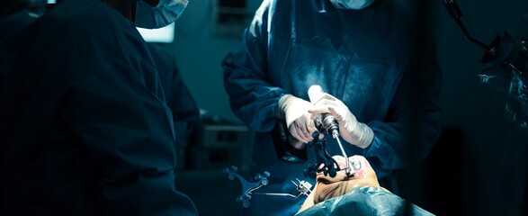 In a sterile operating room, surgeons perform a total knee arthroplasty using the robotical surgery knee system. The robotic-assisted technology aims to enhance precision and improve patient outcomes