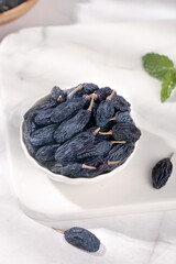 Black Xinjiang Turpan Raisins in White Bowl - Premium Dried Grapes from China