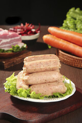 Raw Seasoned Sausages with Fresh Herbs on Wooden Kitchen Table Ready for Barbecue Cooking