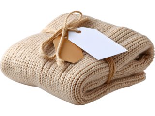 Warm knitted beige blanket tied with string and tag isolated on transparent background, perfect for cozy home and gift themes.