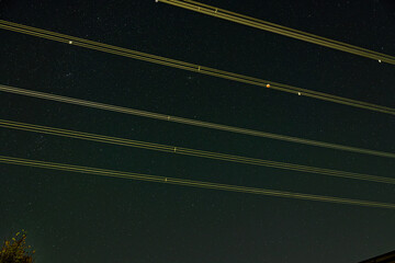 Clear night sky with power transmission lines and stars