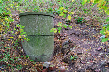 Old concrete ventilation shaft surrounded by autumn nature showing decay and infrastructure history