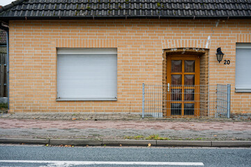 Single story brick house with temporary barrier at entry